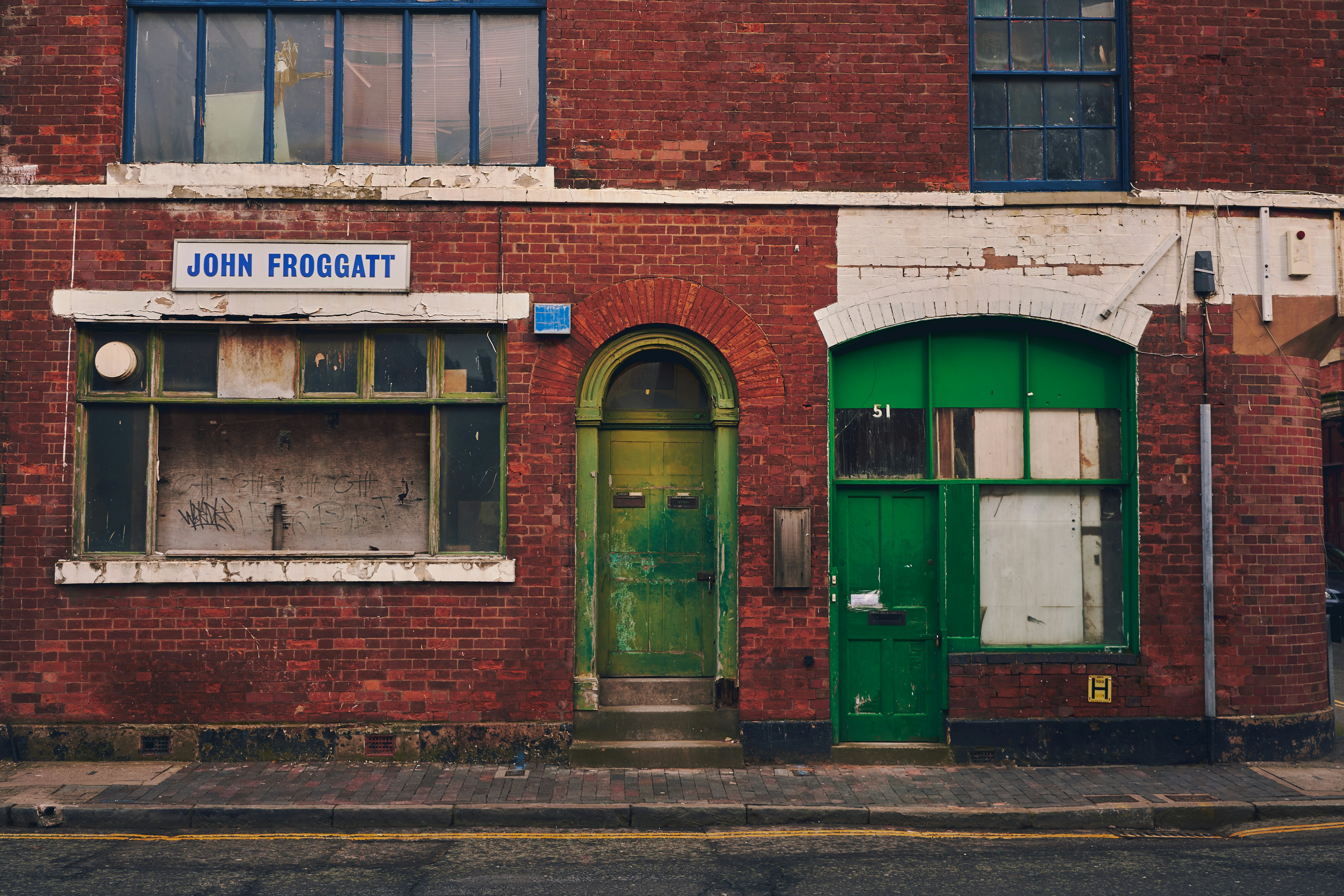 brown brick building with green door